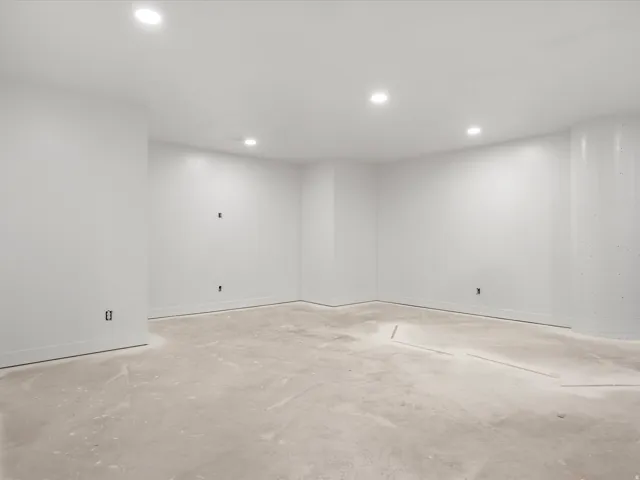 Unfinished interior space featuring white walls and a concrete floor