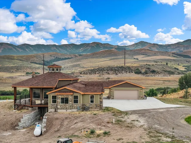 This property features a multi-level residence with a distinct cupola, an attached two-car garage, and a spacious concrete driveway