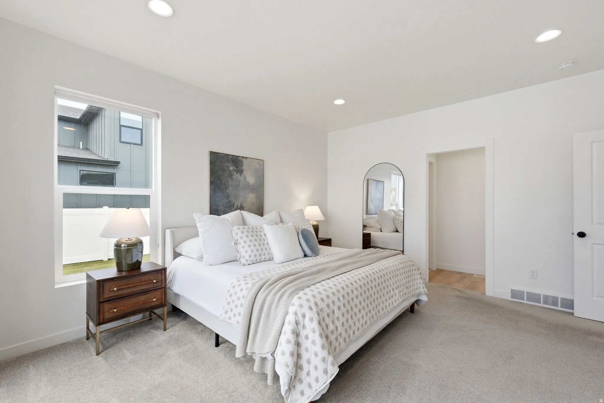 Bedroom featuring light gray carpet flooring and white walls