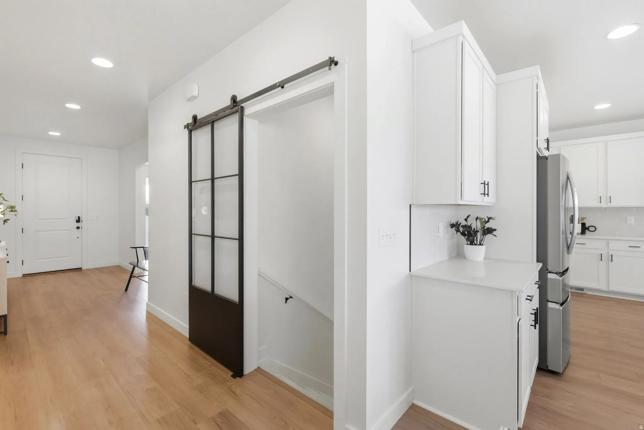 Light wood-finish flooring extending from the entryway