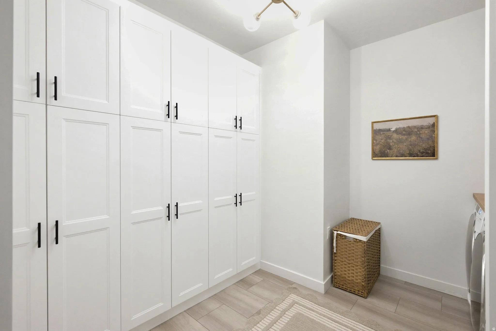 Extensive built-in white cabinetry with black hardware