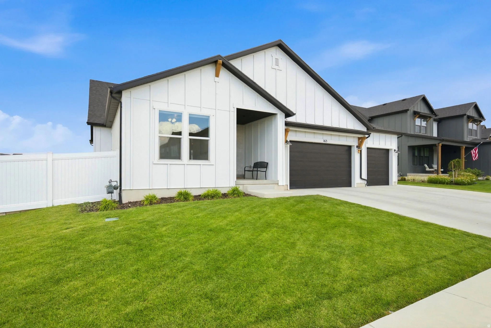 Modern farmhouse exterior featuring white board and batten siding with dark trim accents