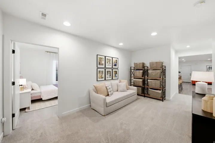 Carpeted hallway space featuring recessed lighting