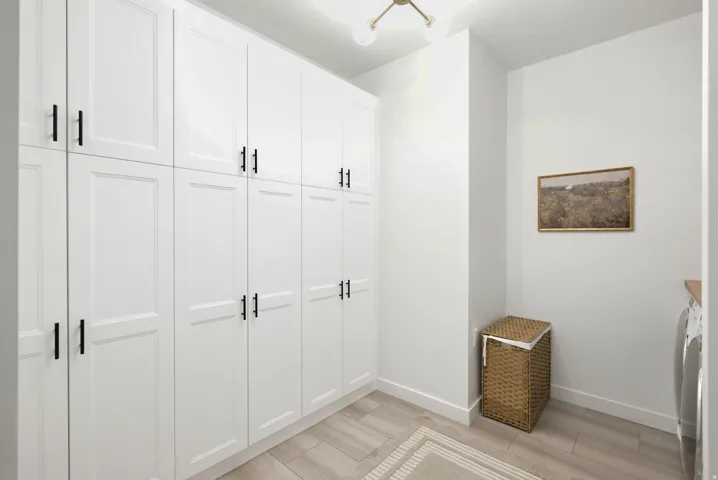 Extensive built-in white cabinetry with black hardware