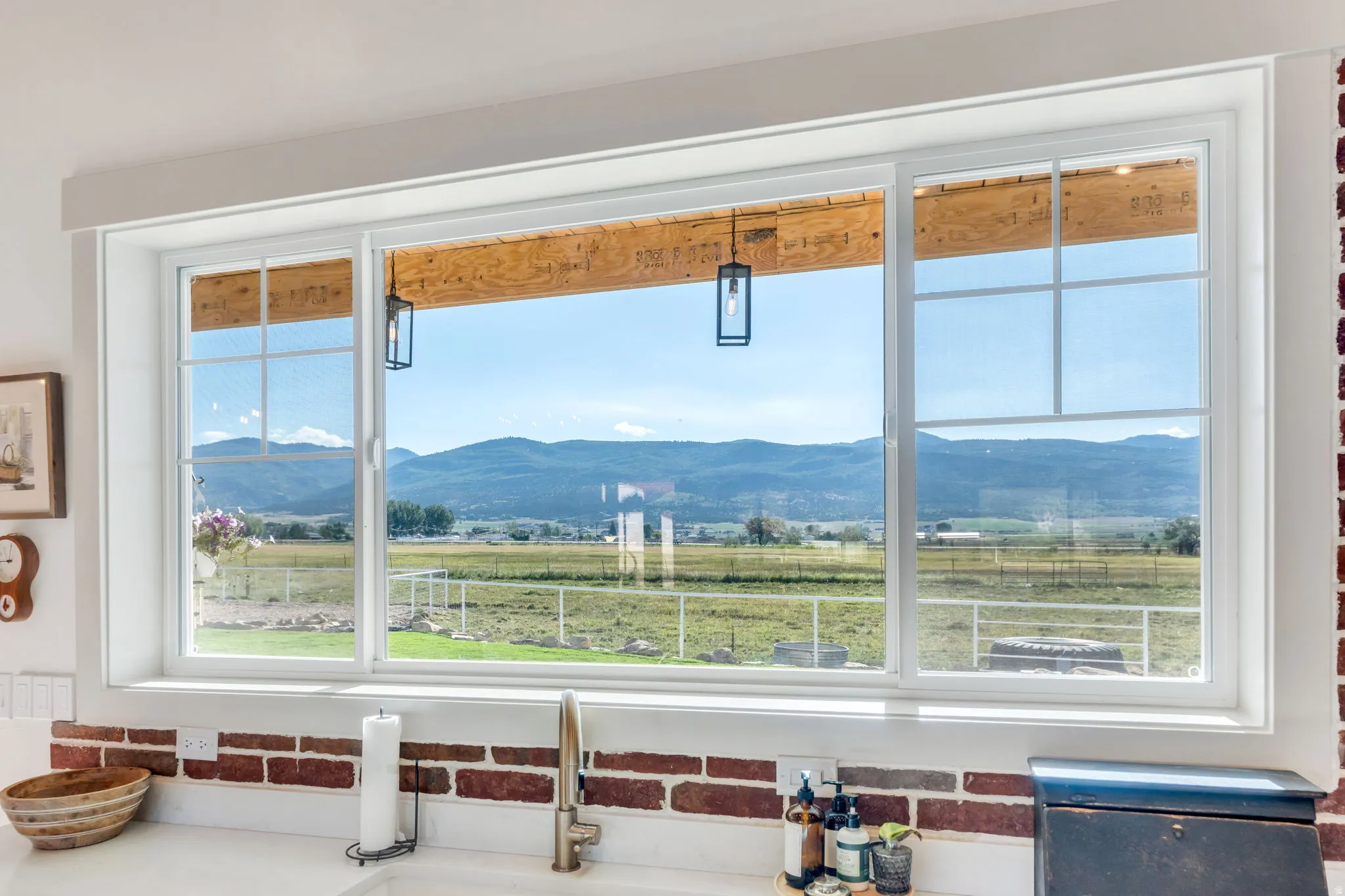 Expansive kitchen window featuring a white frame and grid detailing