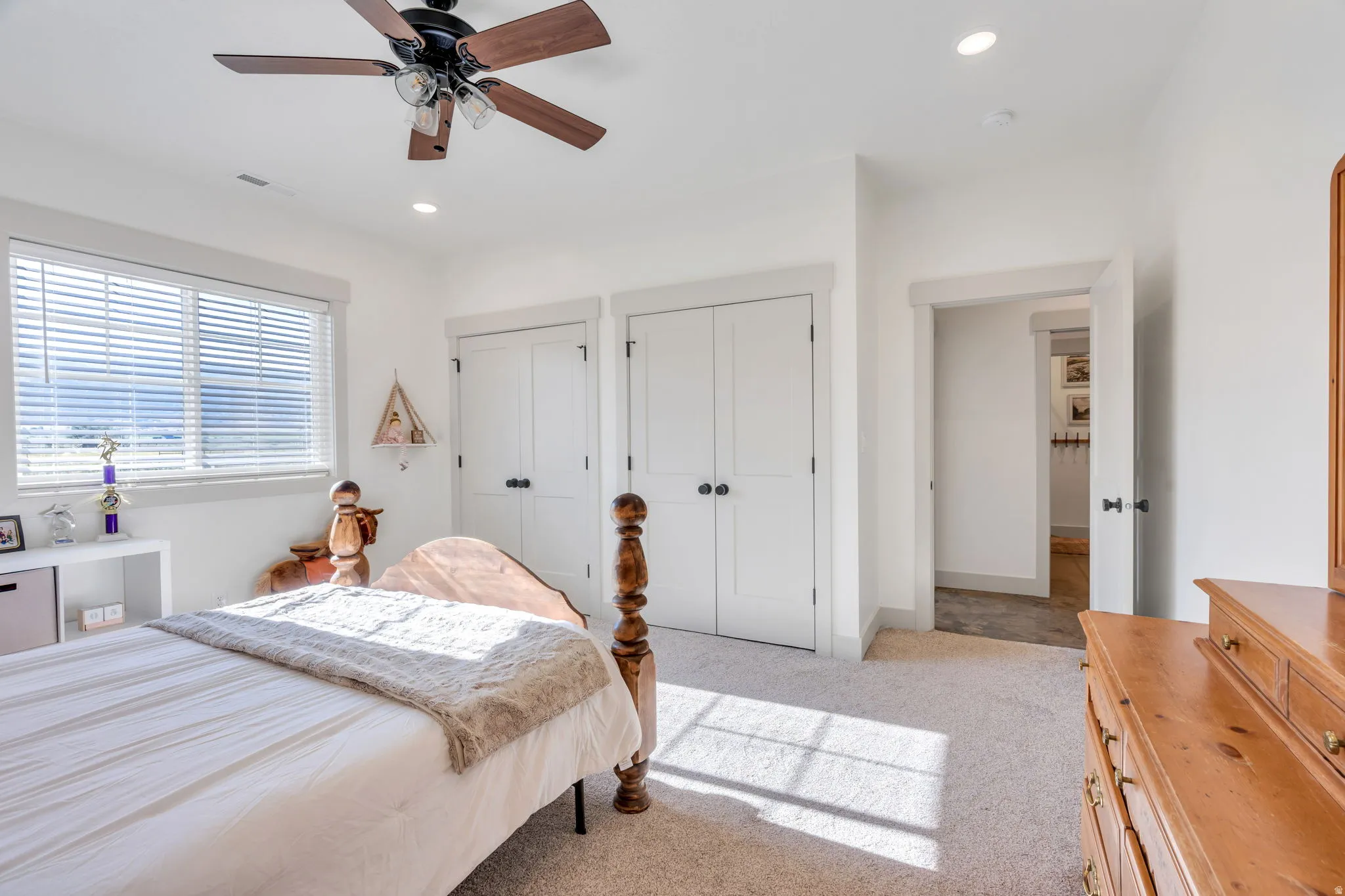 Bright room featuring white walls and neutral carpet flooring