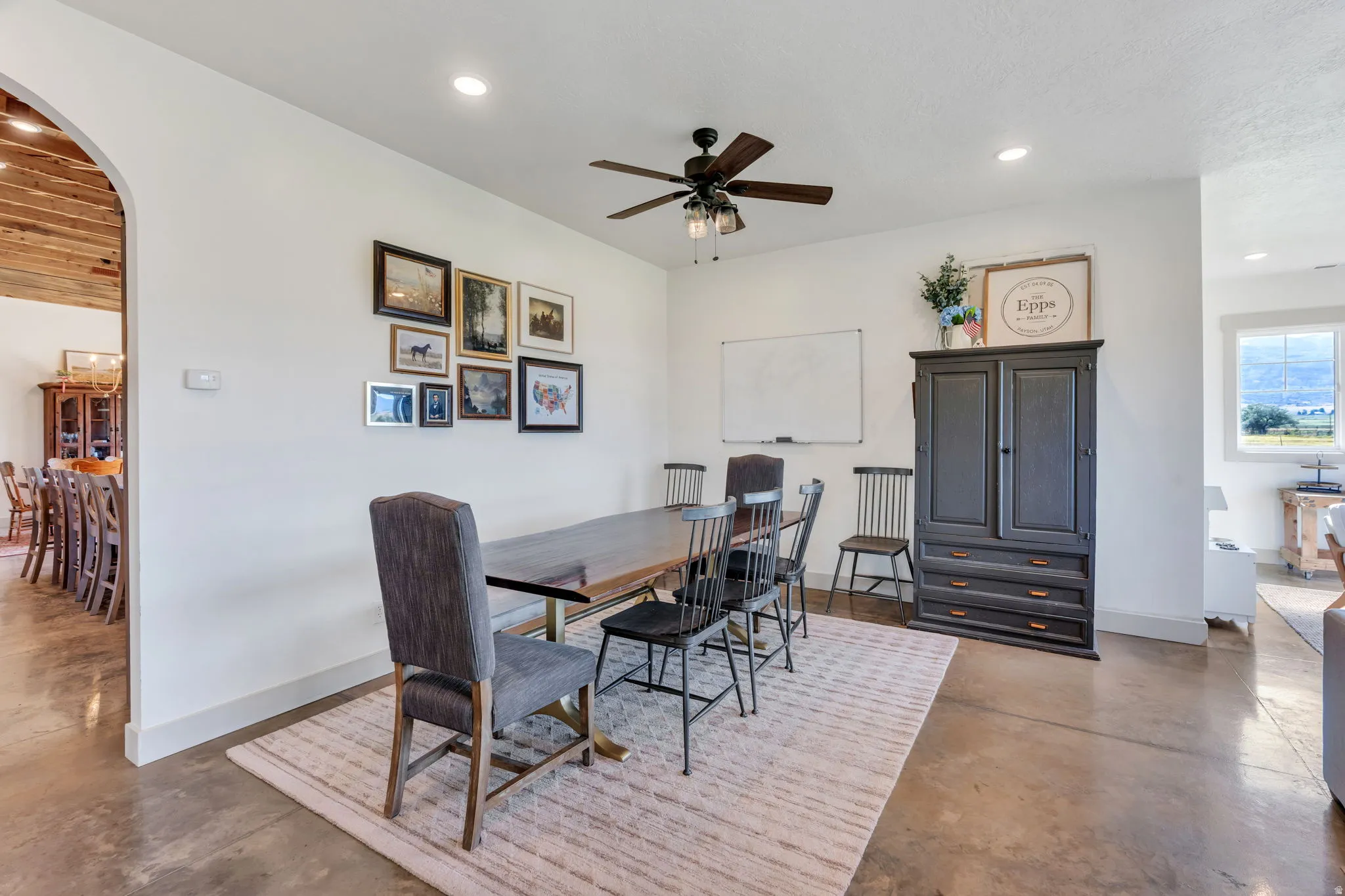 Dining area with concrete flooring and recessed lighting