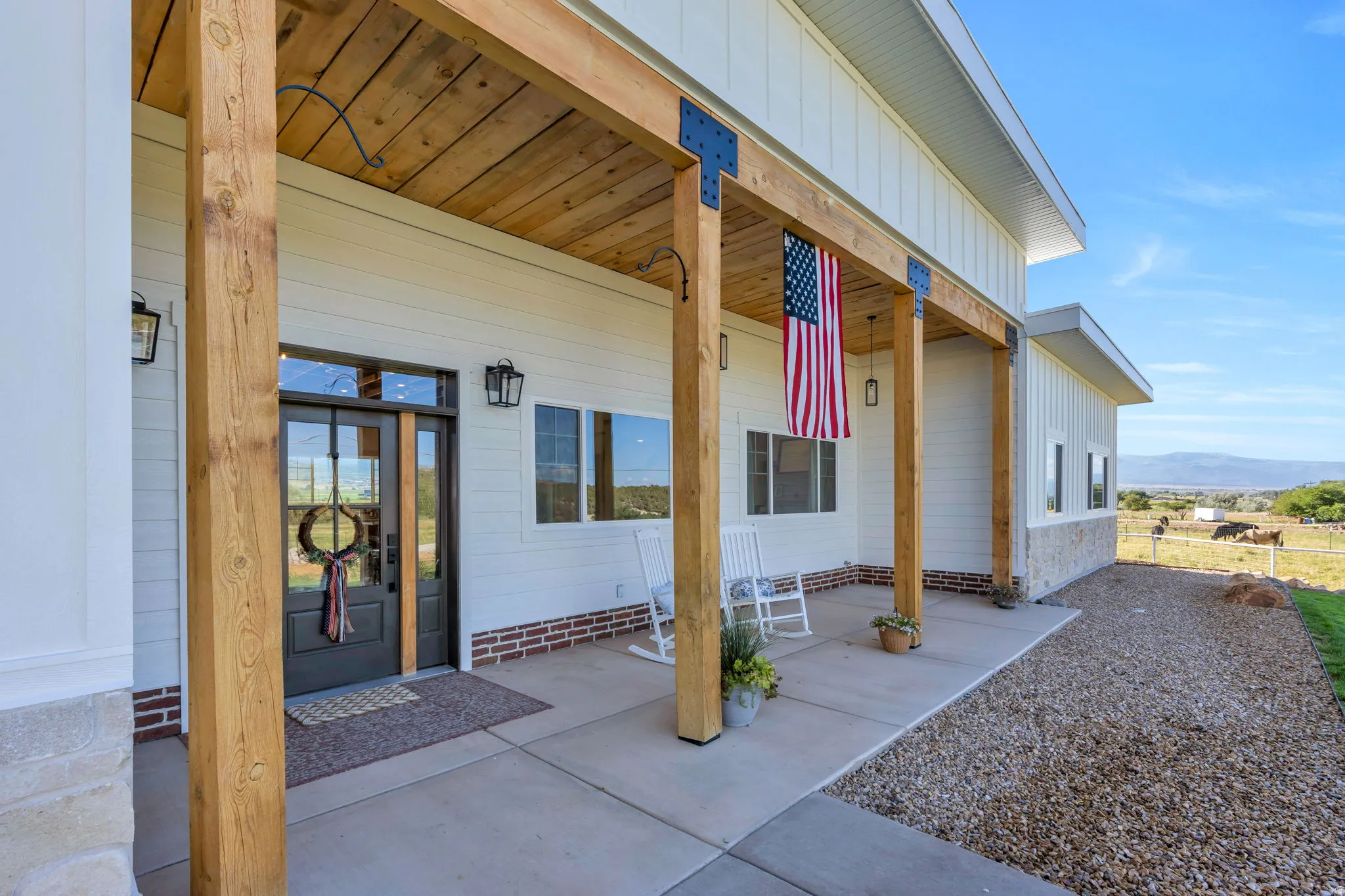 Inviting covered porch with exposed wood beams and ceiling detail