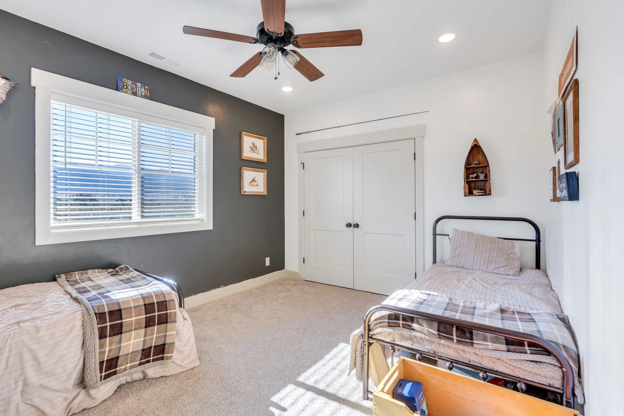 Bright room featuring a window with horizontal blinds, a ceiling fan with integrated lighting, recessed lighting, carpet flooring, and white double closet doors with dark hardware