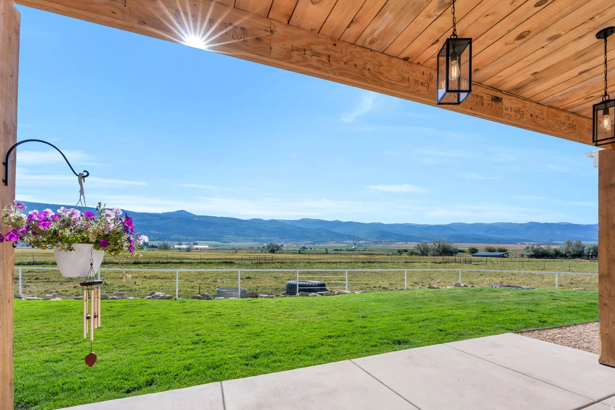 Covered patio featuring an exposed wood beam ceiling and concrete flooring