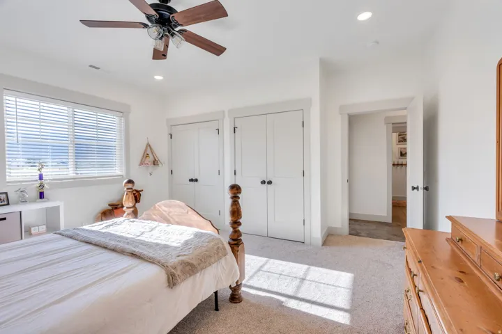 Bright room featuring white walls and neutral carpet flooring