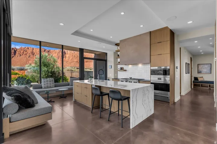 Kitchen to the dining room area with cascading Calcutta Quartzite countertops