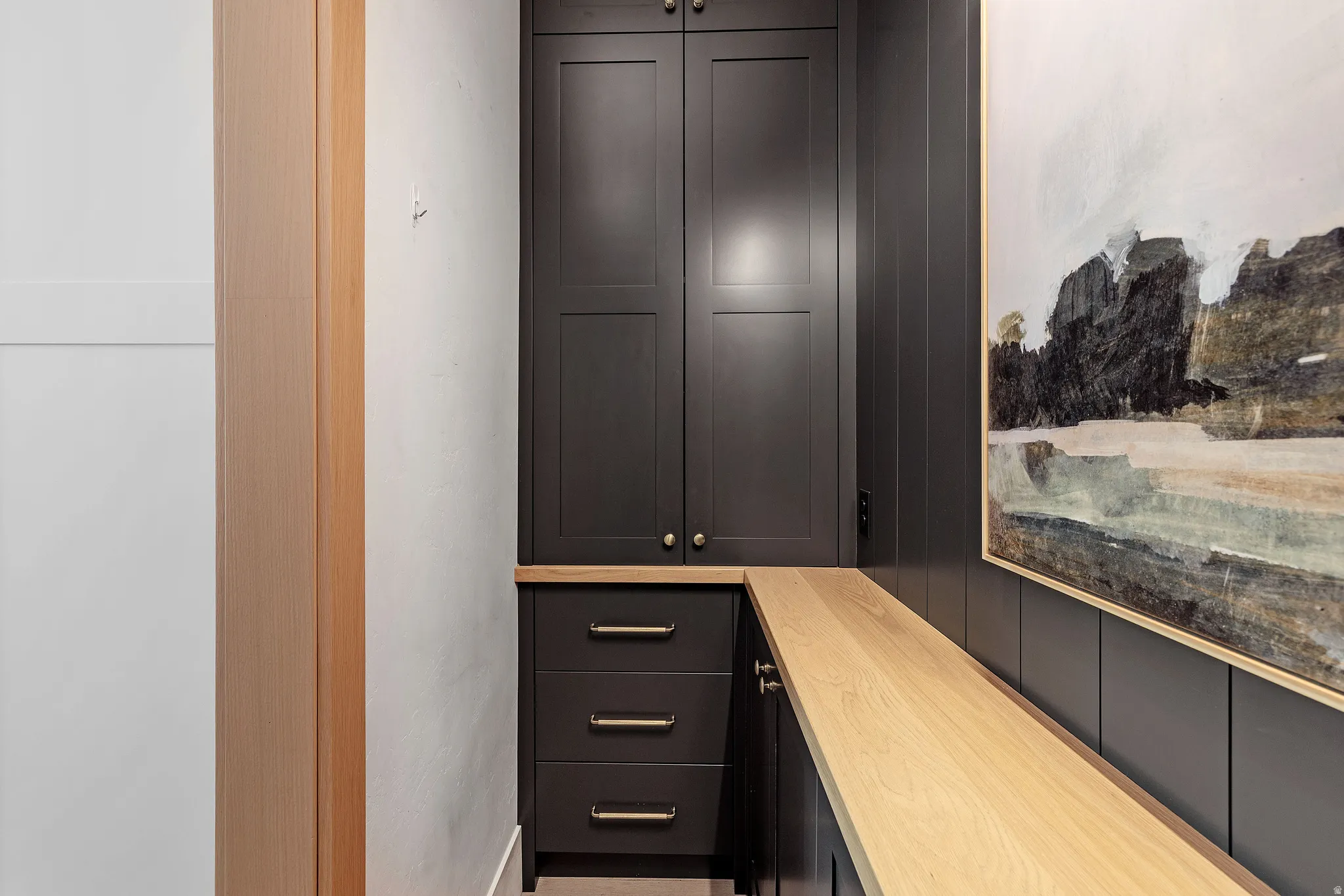 Custom built-in cabinetry, oak wood countertop, and matching soft close doors and drawers