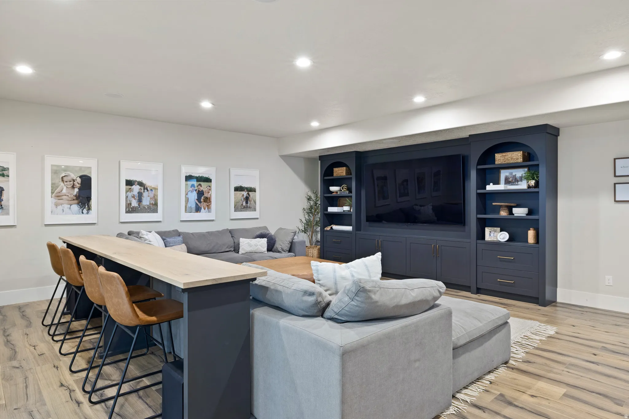 Downstairs built-in entertainment center featuring extensive cabinetry and shelving.