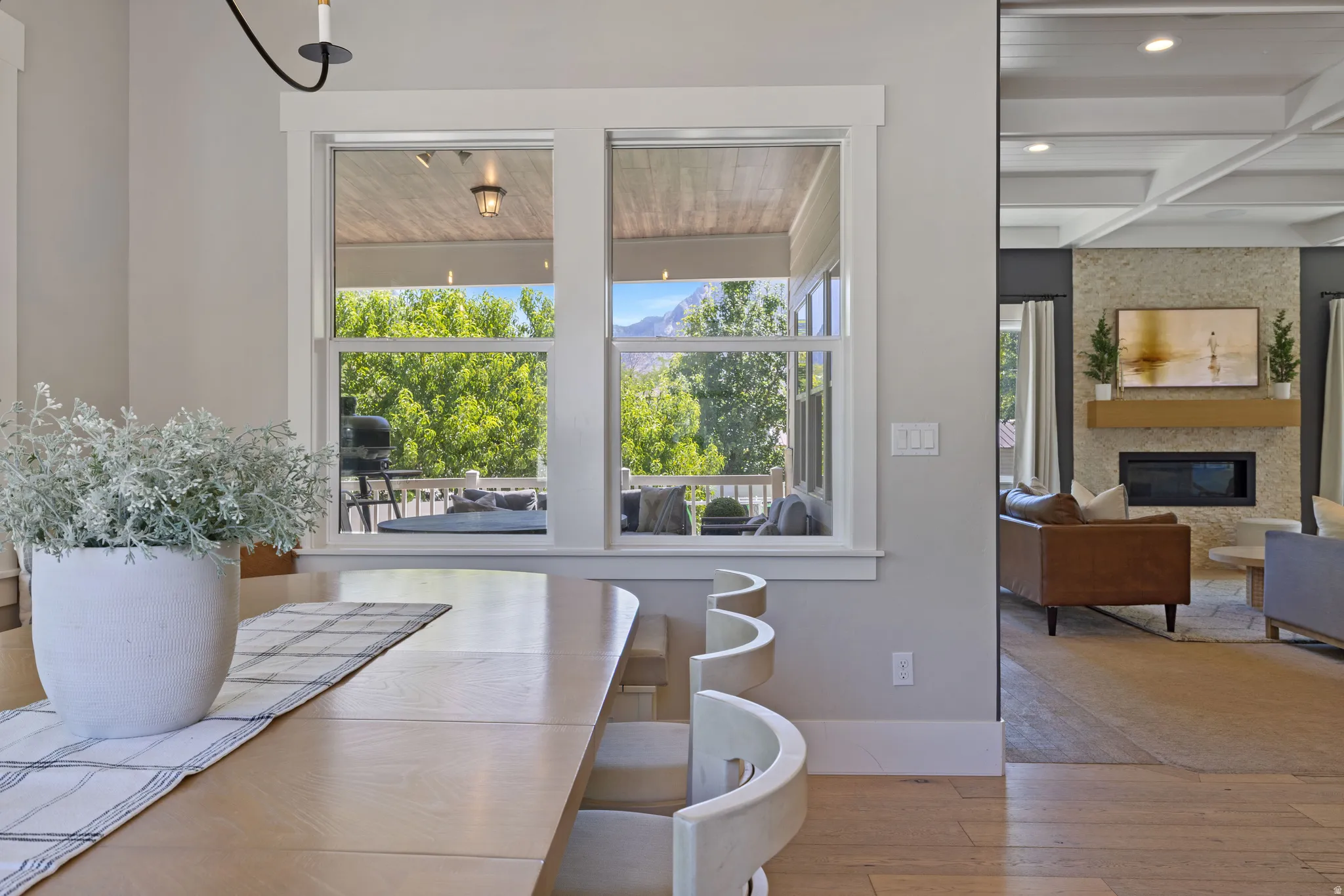 Dining area with light wood-finish flooring and a light-toned dining table