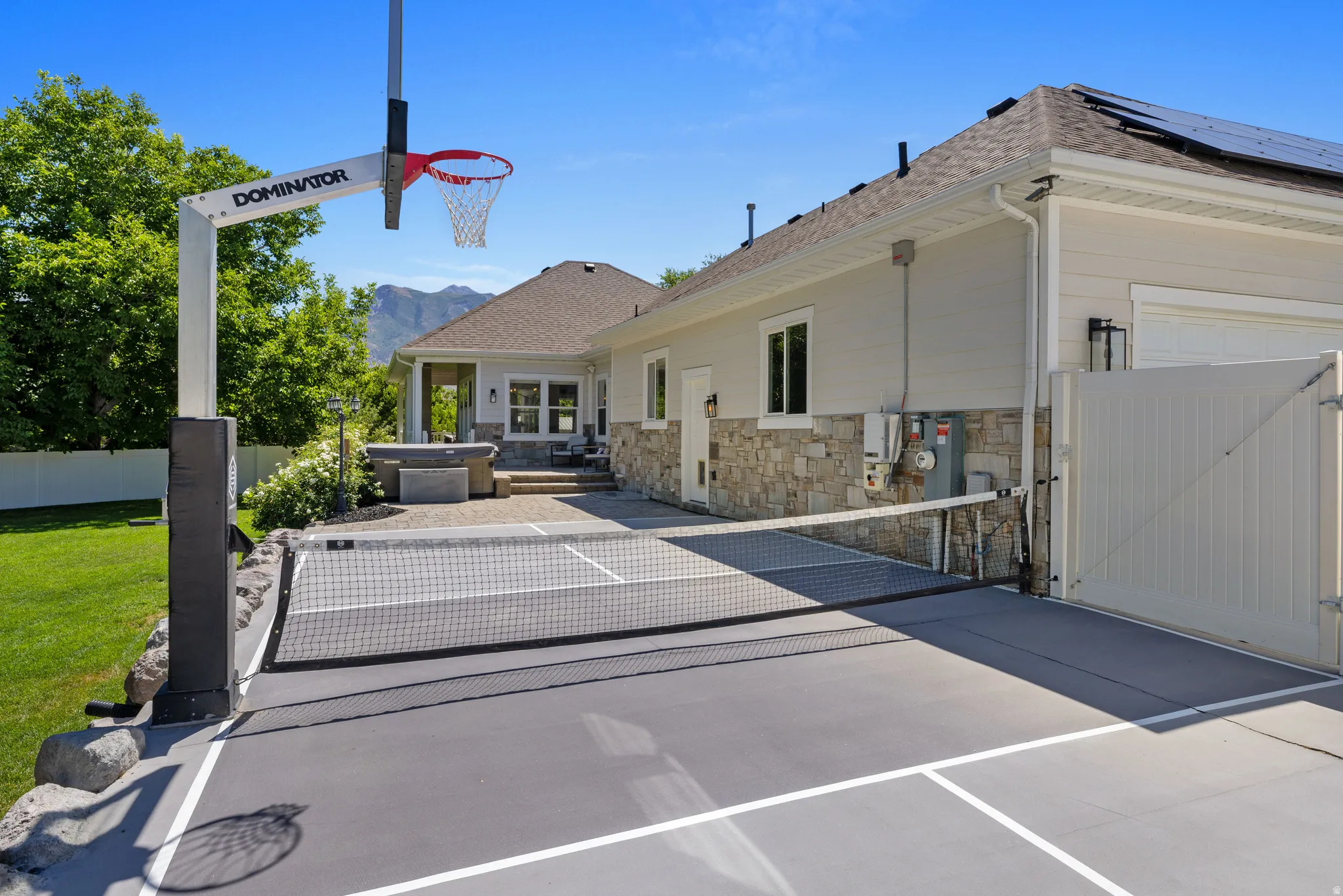 Multi-sport court with basketball hoop and Pickleball net