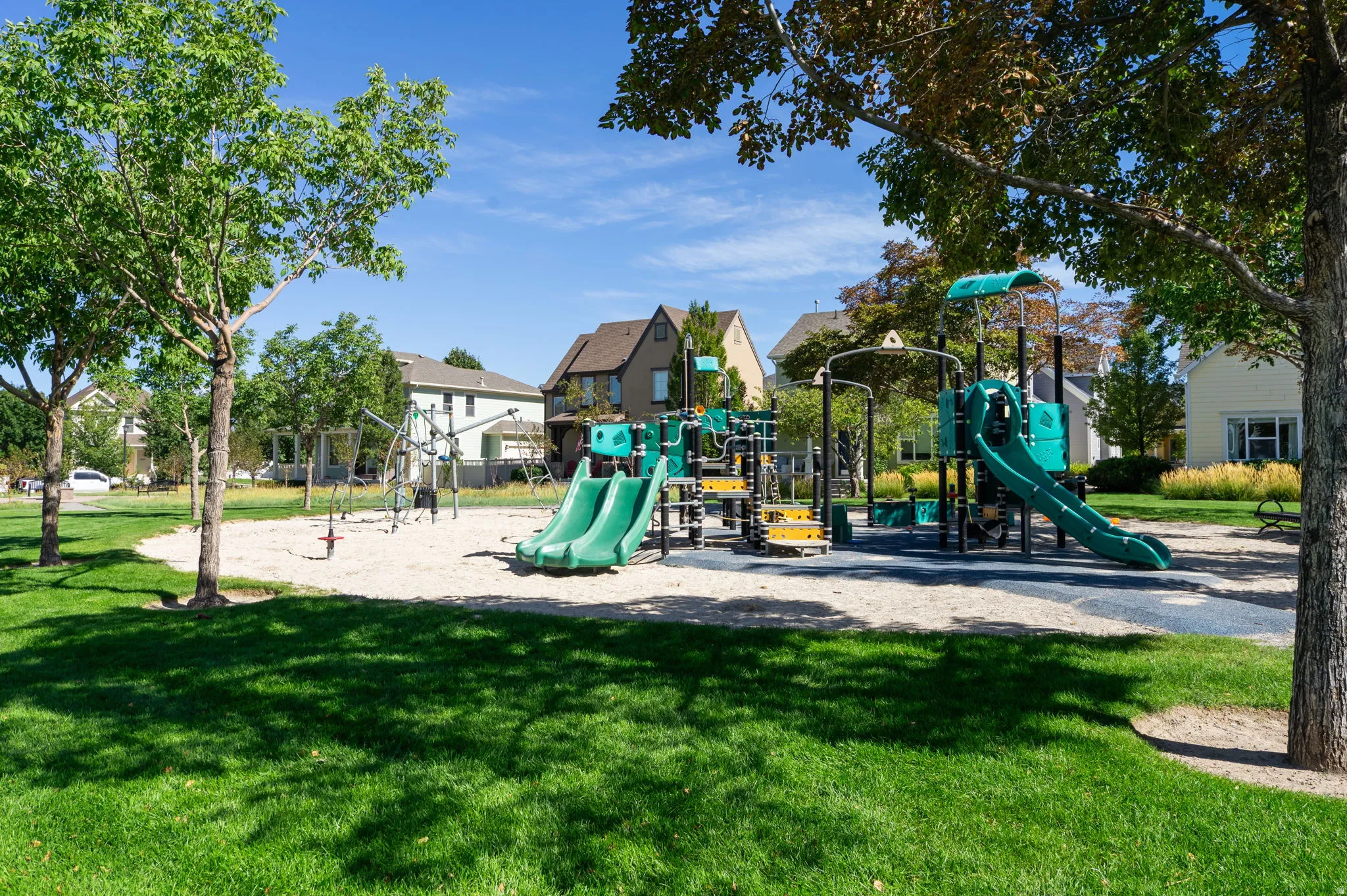 Community playground featuring multiple slides and climbing structures
