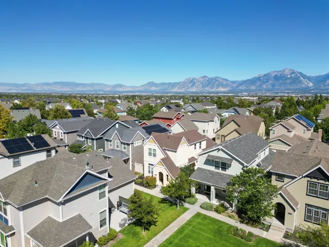 Expansive neighborhood setting with established homes, mature trees, and mountainous backdrop