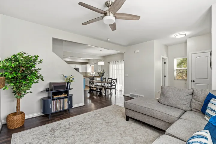 Recessed lighting, wood-finish flooring, and an overhead fan with integrated lighting