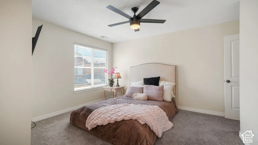 Upstairs Guest On-Suite Bedroom featuring carpet flooring and light-toned walls