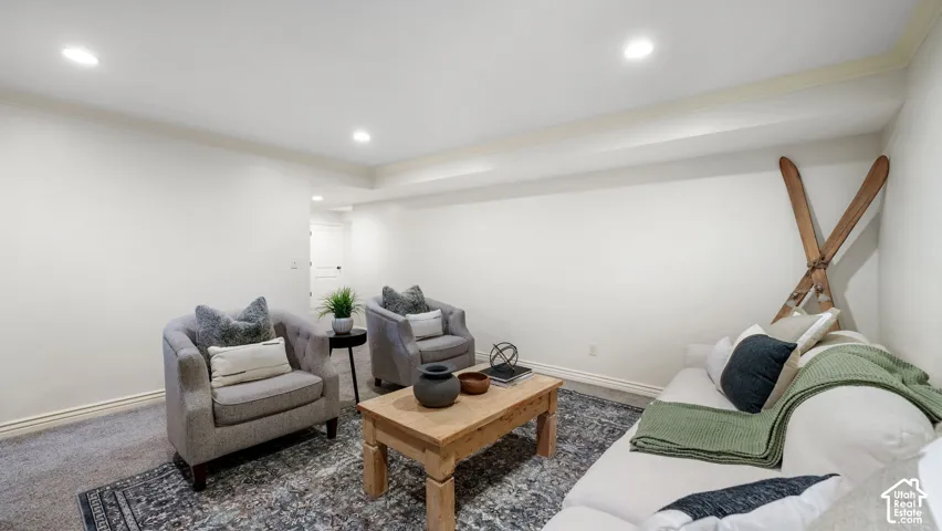 Carpeted living space with recessed lighting, a neutral color palette, and white baseboards