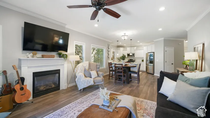 Open-concept living space featuring wood-finish flooring and light-toned walls