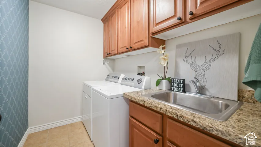 Utility room featuring a built-in stainless steel sink, wood cabinetry, and a granite-look countertop