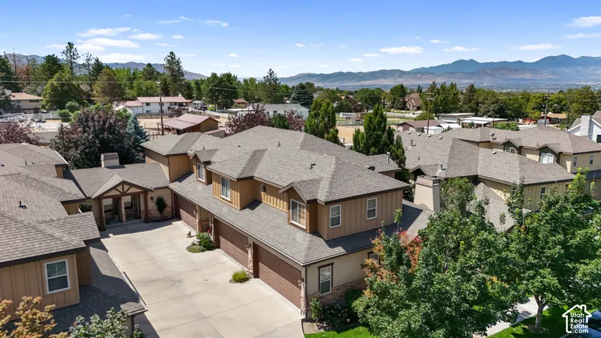 Residential complex featuring multiple units, each with a dedicated garage and individual entryways