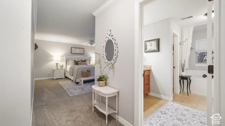 Bedroom featuring vaulted ceilings, ceiling fan, and carpeted flooring