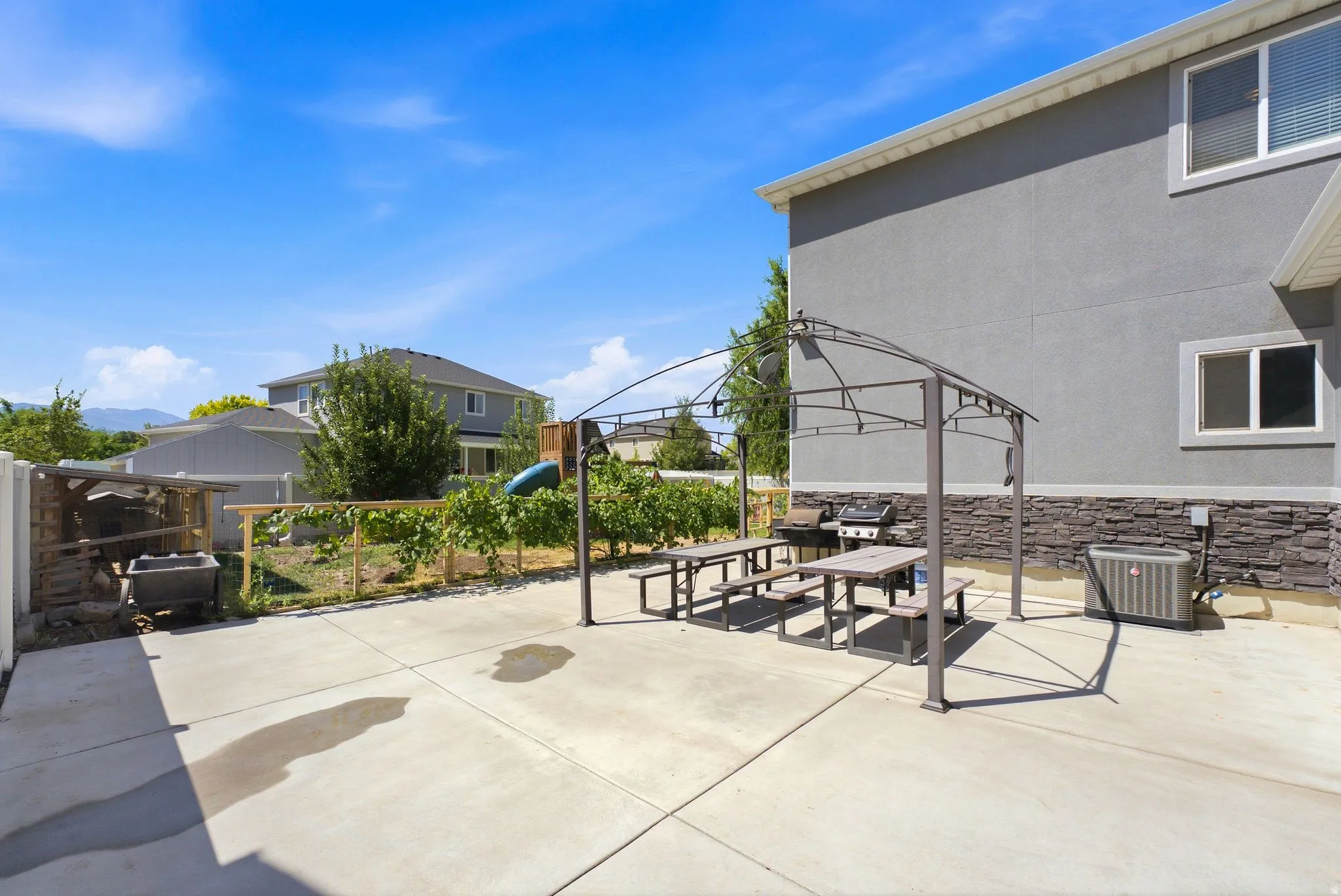 Spacious concrete patio with a permanent pergola structure