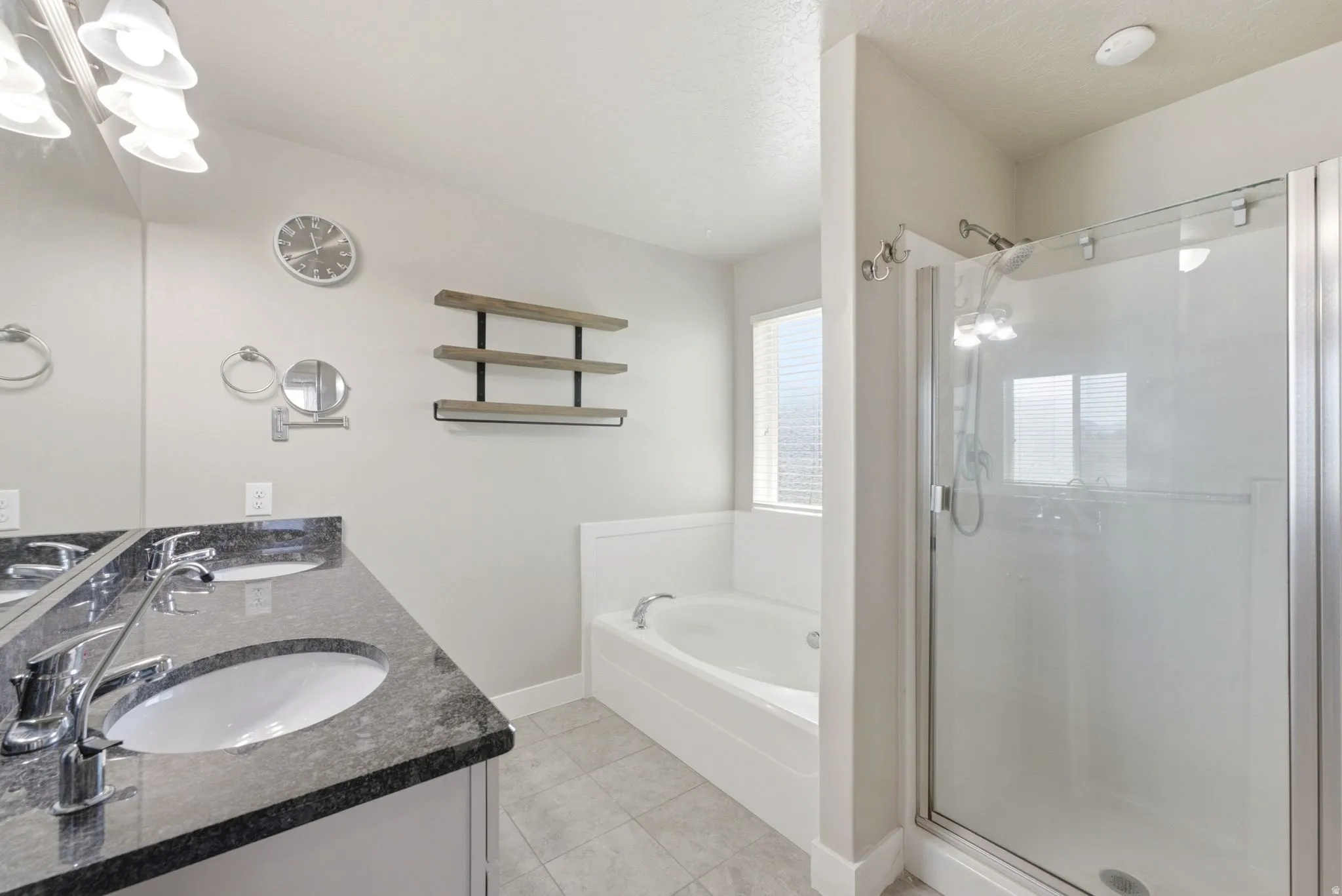 Dual vanity with dark granite-style countertops and chrome fixtures