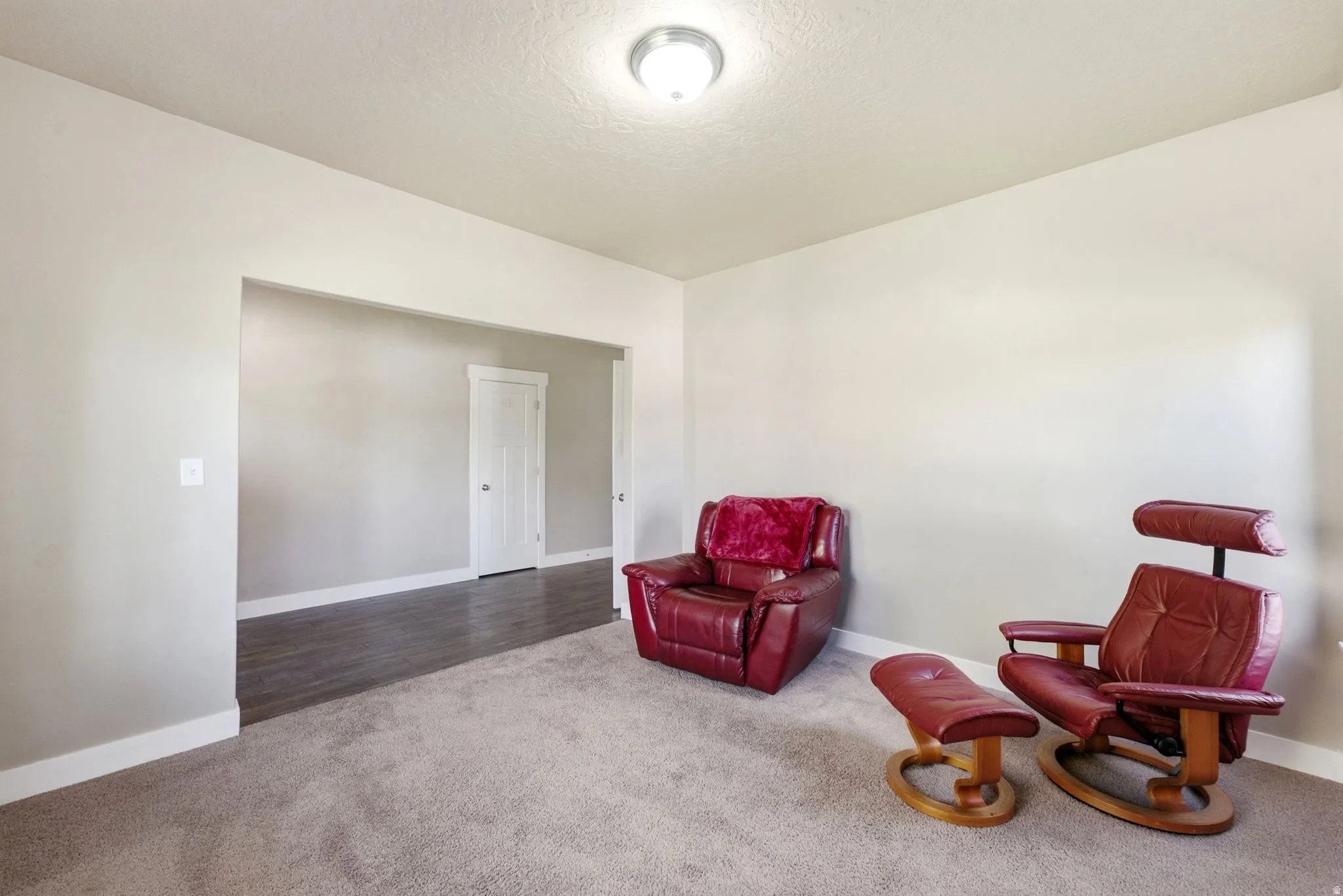 Spacious interior with neutral wall tones and recessed lighting