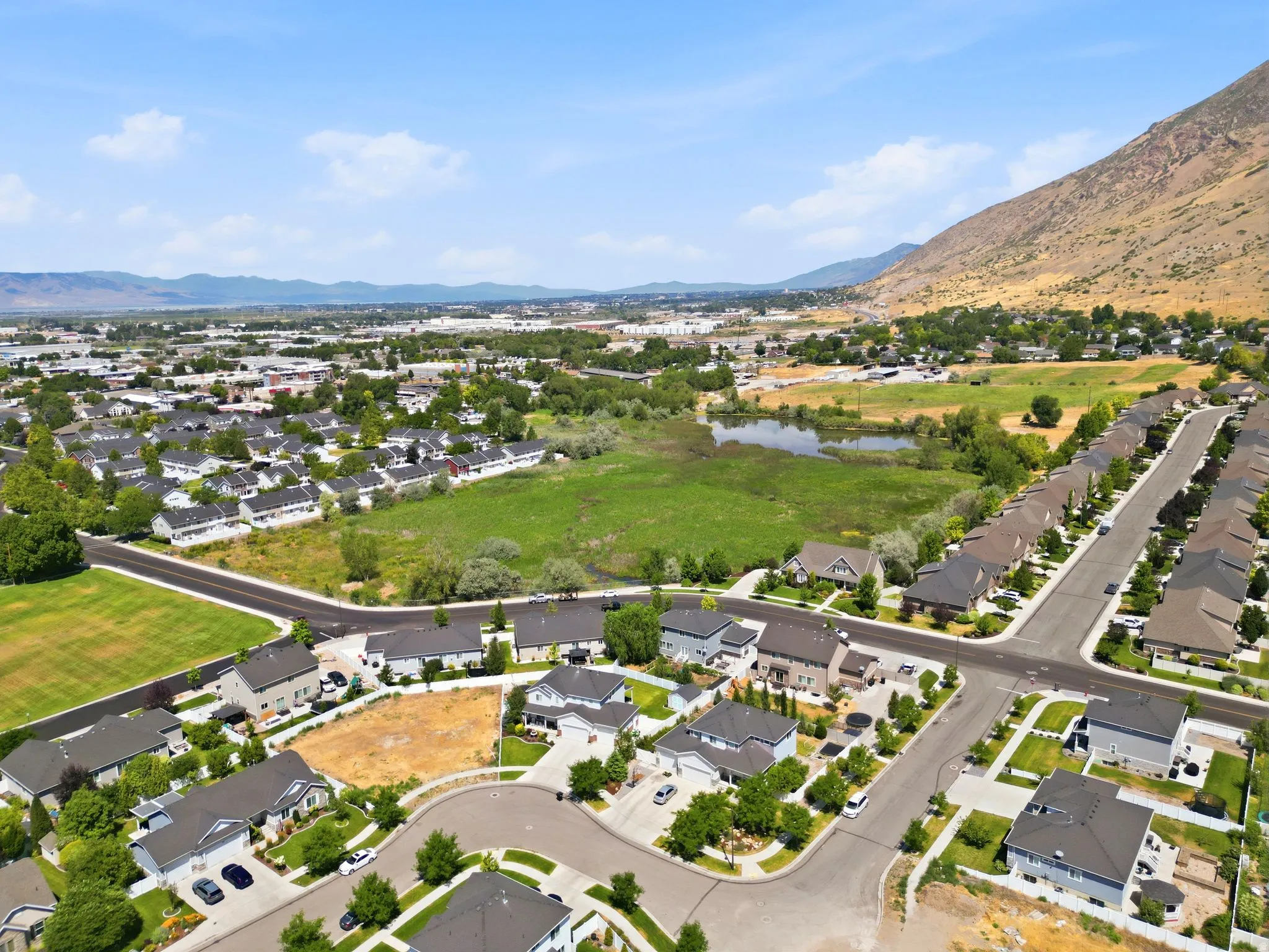 Aerial view showcasing a residential development with a mountain backdrop