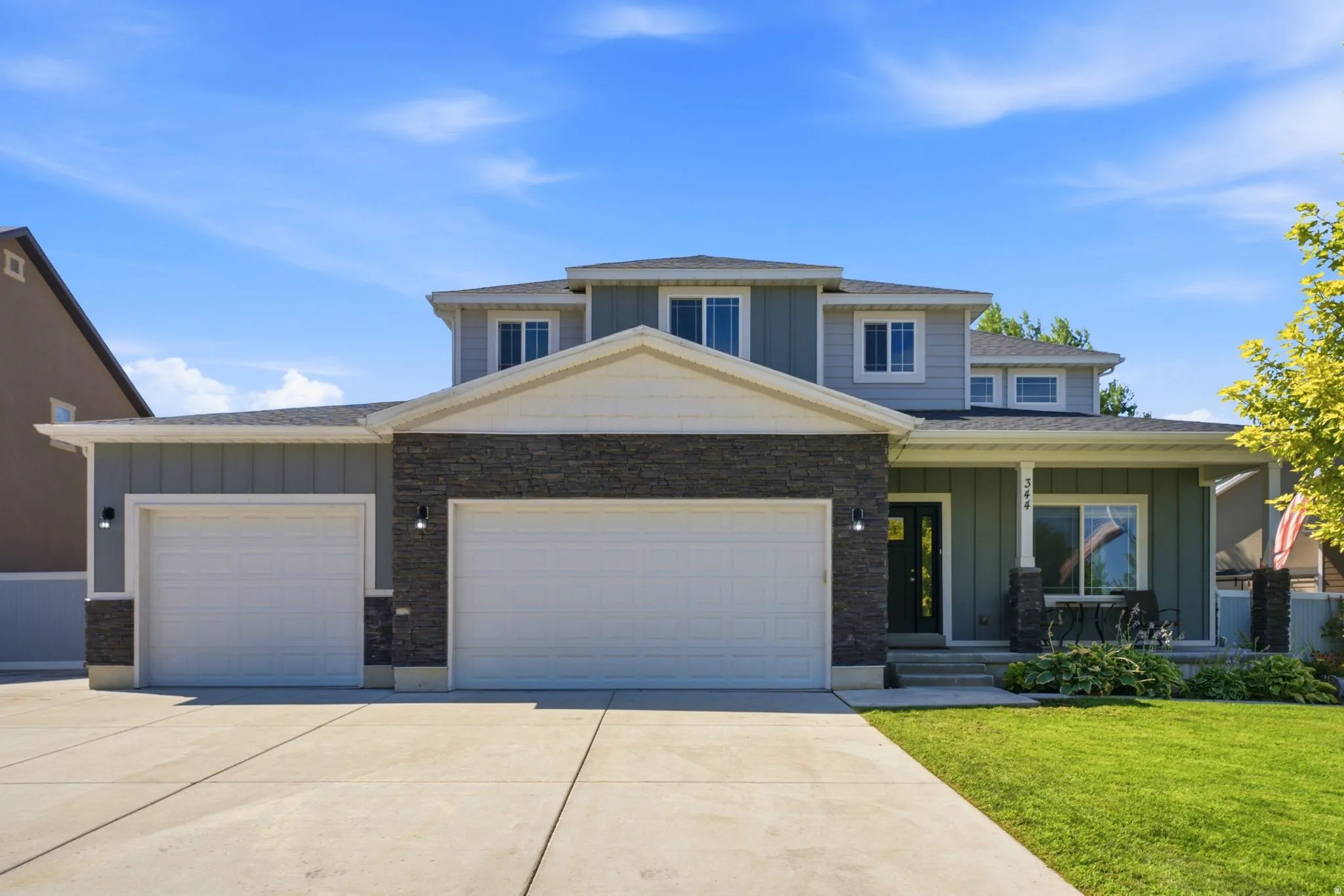 Contemporary two-story residence featuring a combination of siding and stone veneer on the facade