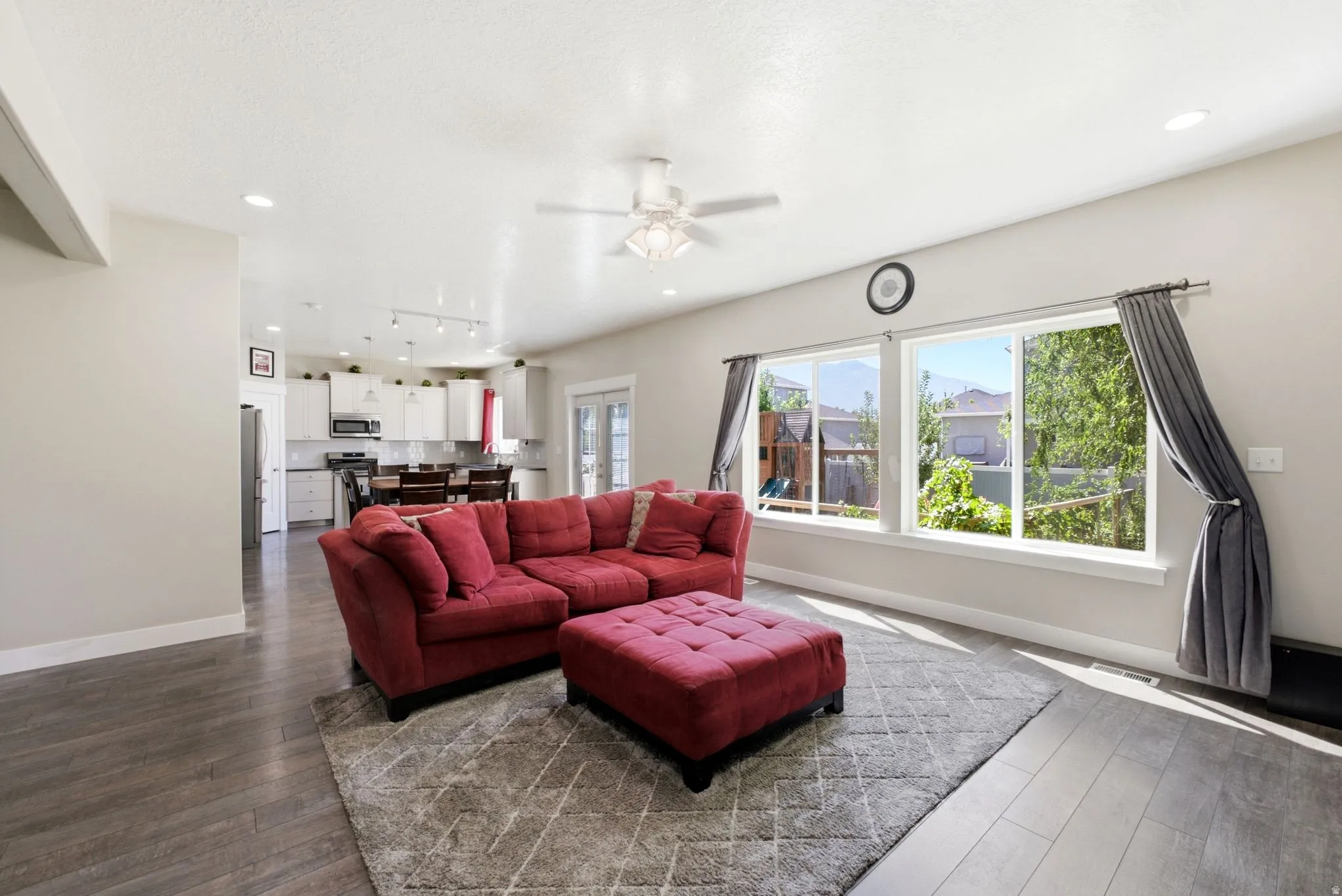 Open-concept living area featuring wood-finish flooring and recessed lighting