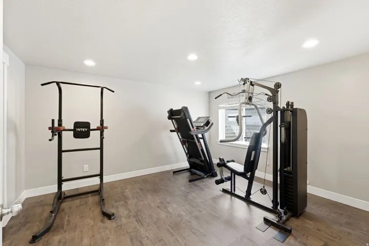 Versatile room featuring wood-finish flooring, recessed lighting, and a window for natural light