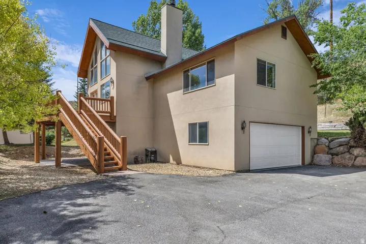 Contemporary-style exterior with a gabled roofline and stucco finish