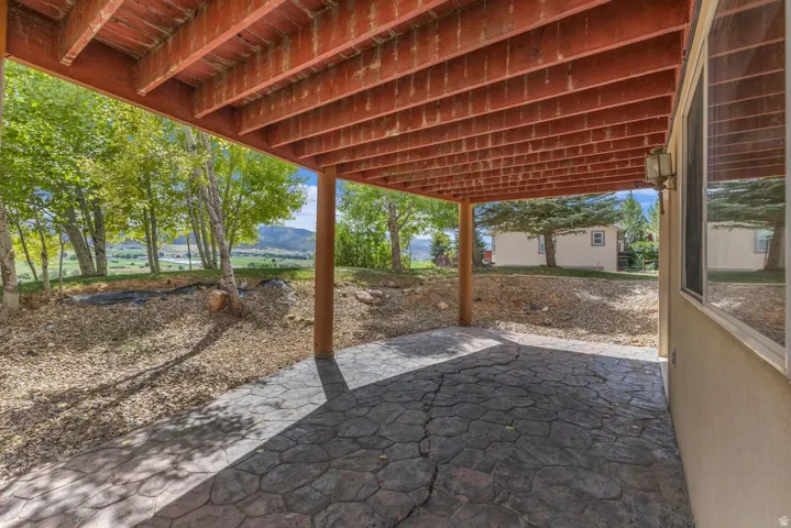 Covered patio featuring stamped concrete flooring