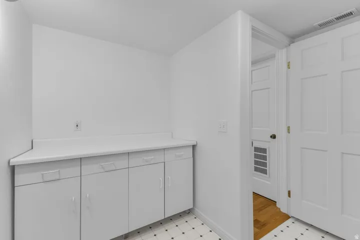 White cabinetry with integrated handles and a light-colored countertop