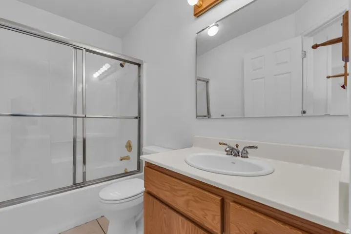 Bathroom featuring a light wood-finish vanity with a white countertop and integrated sink