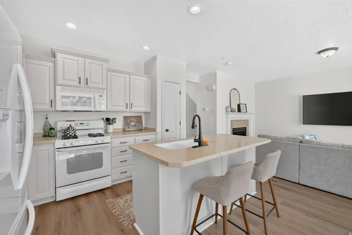 Freshly painted kitchen cabinetry creates a light, bright, and spacious feel. The gas stove is a chef's delight!