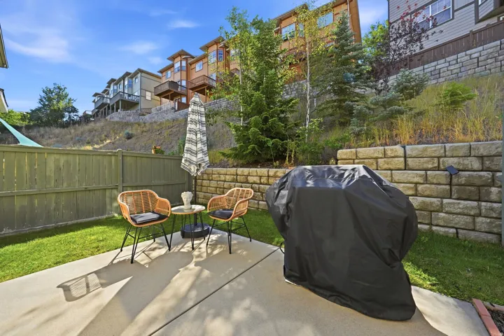 Large fenced in patio for your littles or fur babies! Enjoy the mature trees behind the property that are a rare find in this subdivision