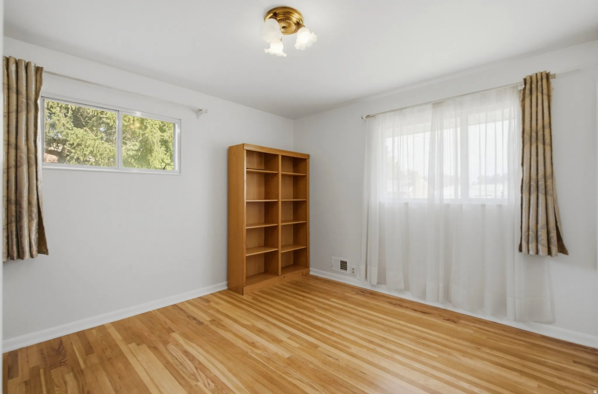 Hardwood flooring featuring natural light from multiple windows
