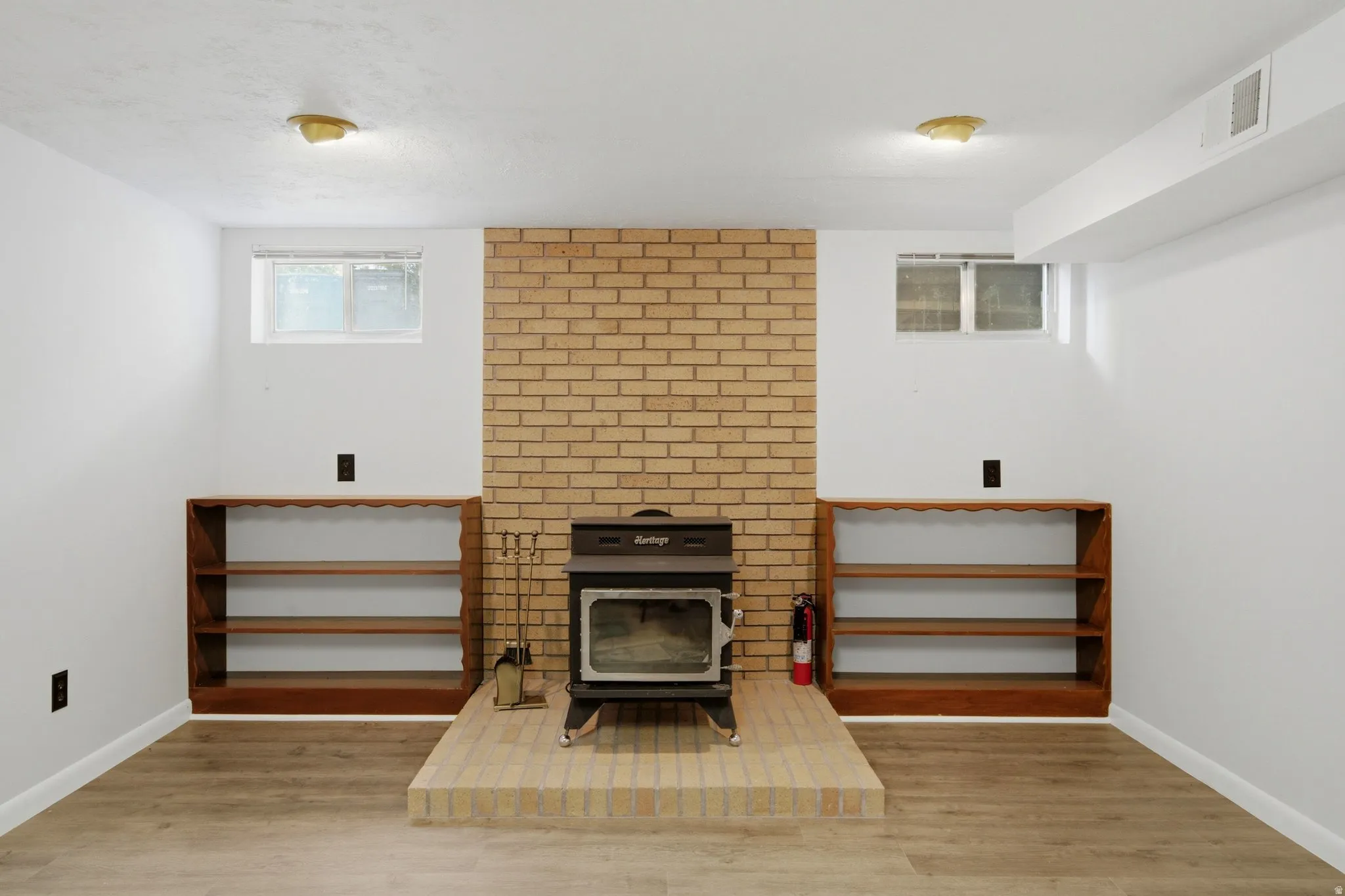 Brick-clad fireplace with a wood-burning stove and a raised hearth