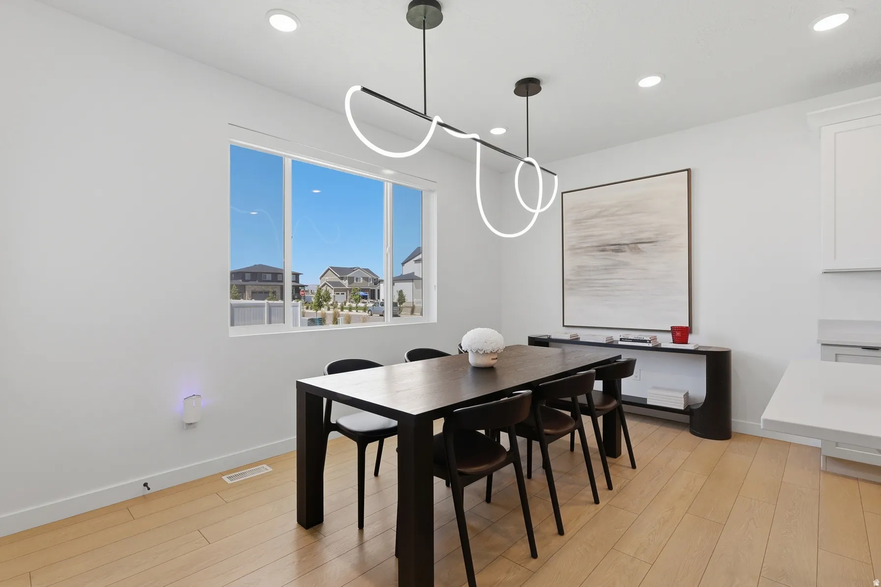 Dining area featuring wood-finish flooring and a large window