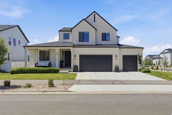Contemporary two-story residence featuring a black and white exterior palette