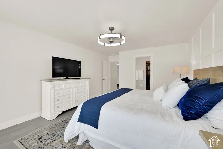 Interior room featuring light-colored walls and wood-finish flooring