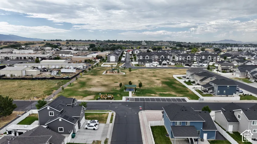 Residential neighborhood featuring a central park area with playground equipment and a covered picnic area