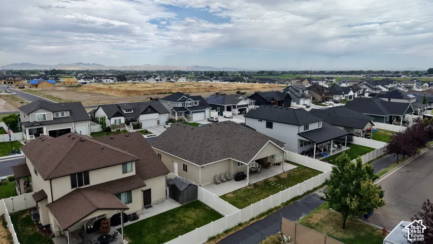 Aerial perspective showcasing a residential neighborhood with a mix of light and dark-colored roofs