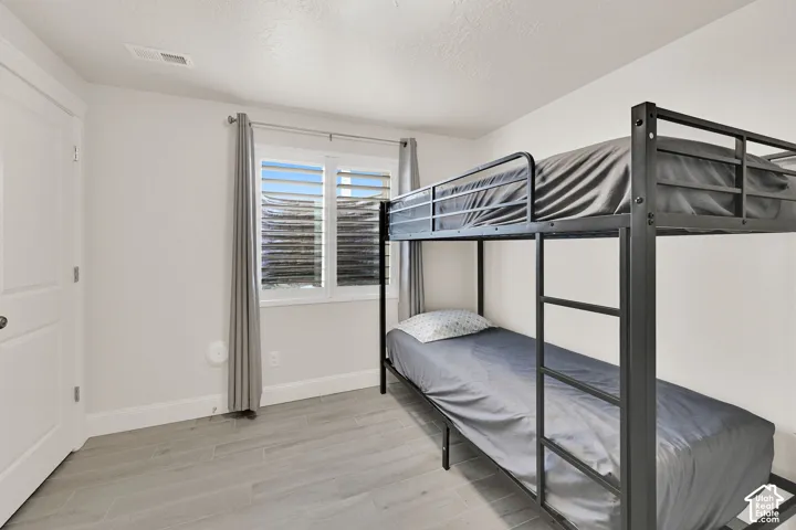 Bedroom featuring light wood-finish flooring and white walls